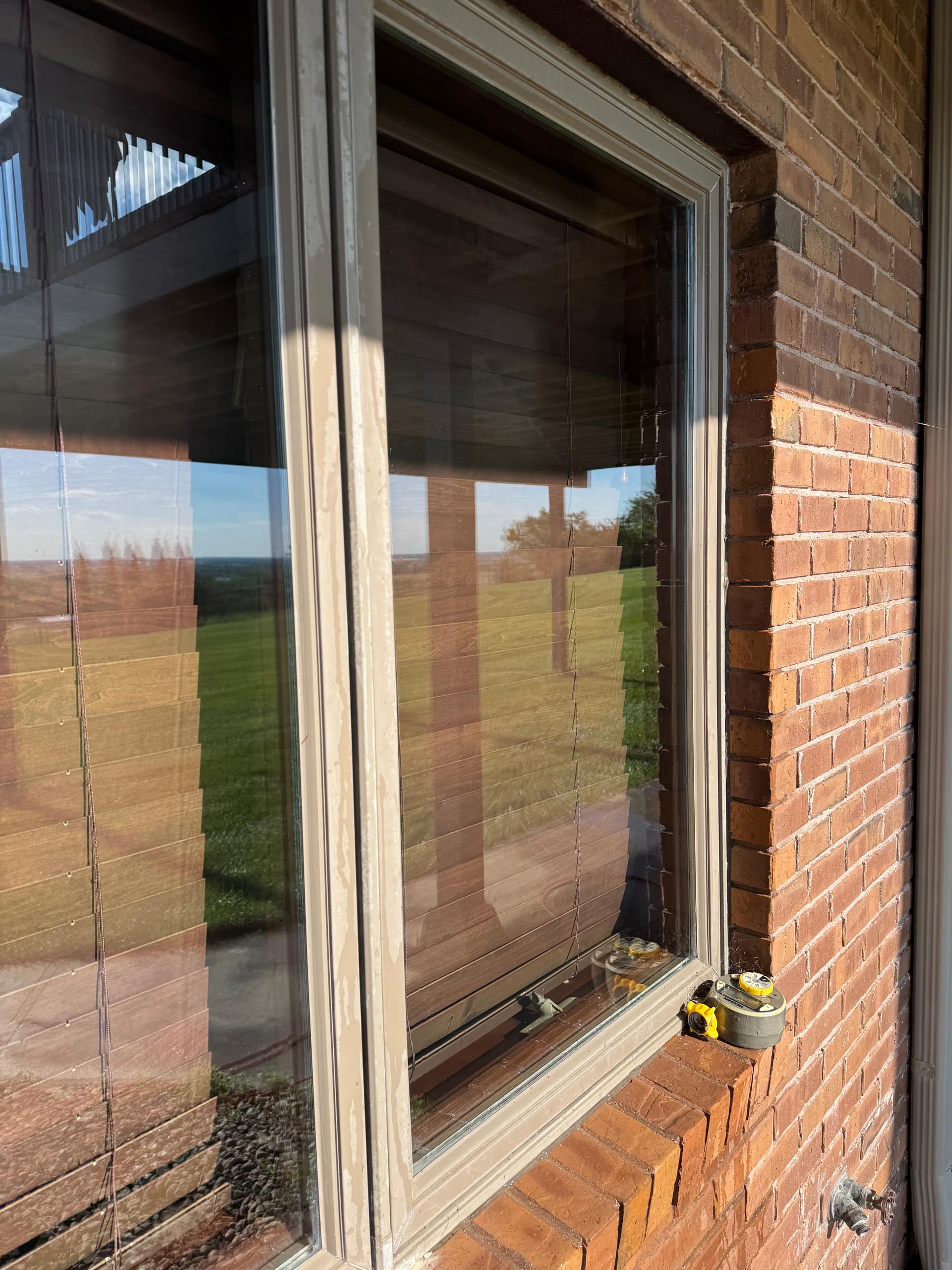 Close-up of the same elevation after Bluetide's hard-water restoration — glass clear to the reflection